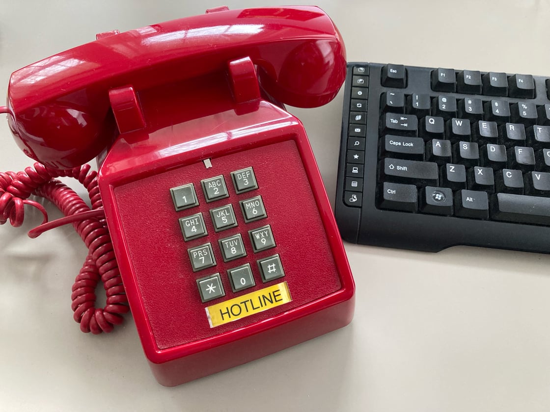 PG Calc's Client Services teams receives many questions from gift planners - image of a red "hotline" phone